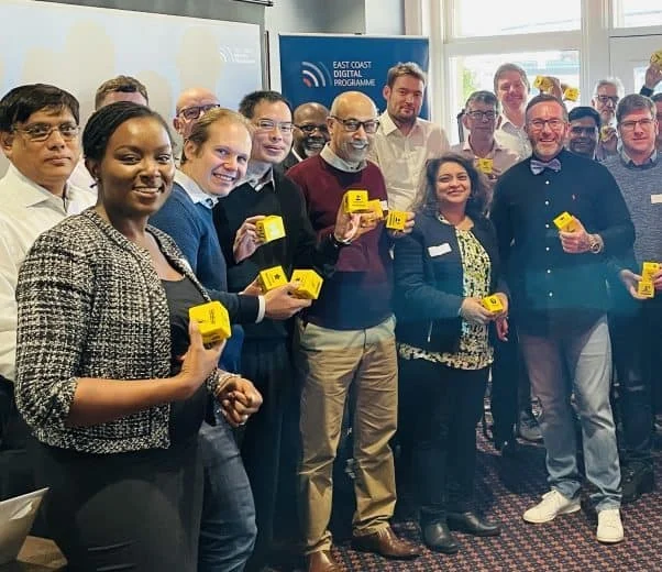 Group of participants holding yellow Huddle Culture Communication Cubes during a workplace communication and behavioural safety session