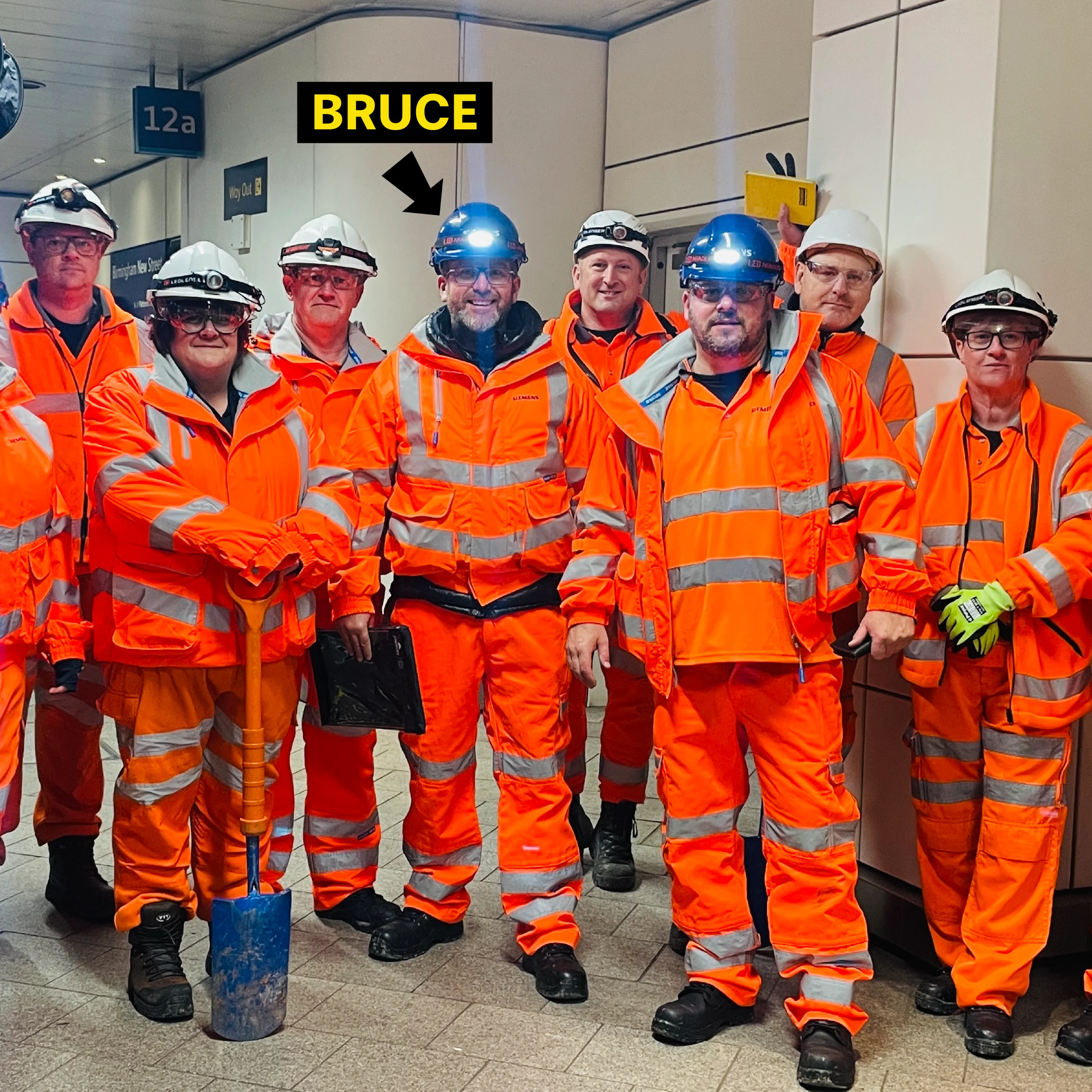 Bruce and Siemens Bruce Durham from Huddle Culture with Siemens Rail employees wearing high-visibility clothing at a railway worksite during a behavioural safety training programme